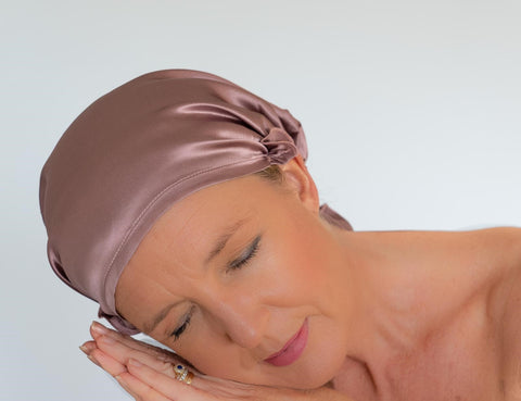 Lady sleeping wearing silk sleep cap to protect hair
